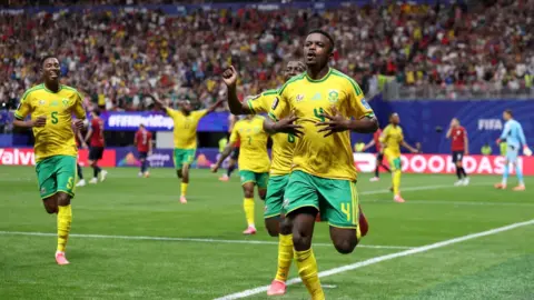 South Africa players celebrate after a match, keeping their FIFA World Cup knockout dream alive.