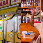 Jaggu Dhaba Tokyo owner serving authentic pani puri on a neon-lit street in Japan.
