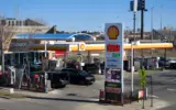 Gas pump displaying a price below $4 per gallon, symbolizing the drop in US gas prices.