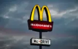 A close-up of a McDonald's Big Mac burger with fries and a drink.