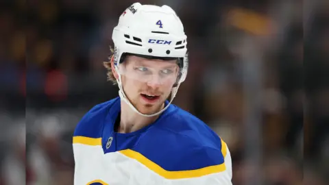 Bowen Byram in action on the ice, with NHL insider Darren Dreger's report fueling trade rumors.
