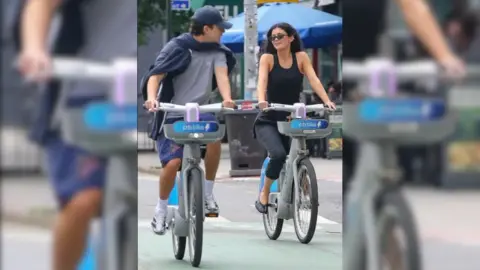 Timothée Chalamet and Kylie Jenner riding bikes together in New York City.