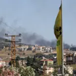 Explosion and smoke rising from a location in Lebanon following Israeli airstrikes, with a subtle background hint of international diplomacy.