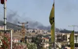 Explosion and smoke rising from a location in Lebanon following Israeli airstrikes, with a subtle background hint of international diplomacy.