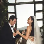 Dua Lipa and Callum Turner smiling at their Italian wedding ceremony.