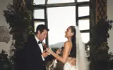 Dua Lipa and Callum Turner smiling at their Italian wedding ceremony.
