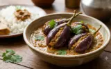 A close-up shot of Guthi Vankaya, a traditional Telangana recipe featuring stuffed eggplants in a rich gravy.