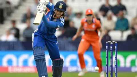 Smriti Mandhana celebrating a milestone during the India vs Netherlands Women's T20 World Cup 2026 match.