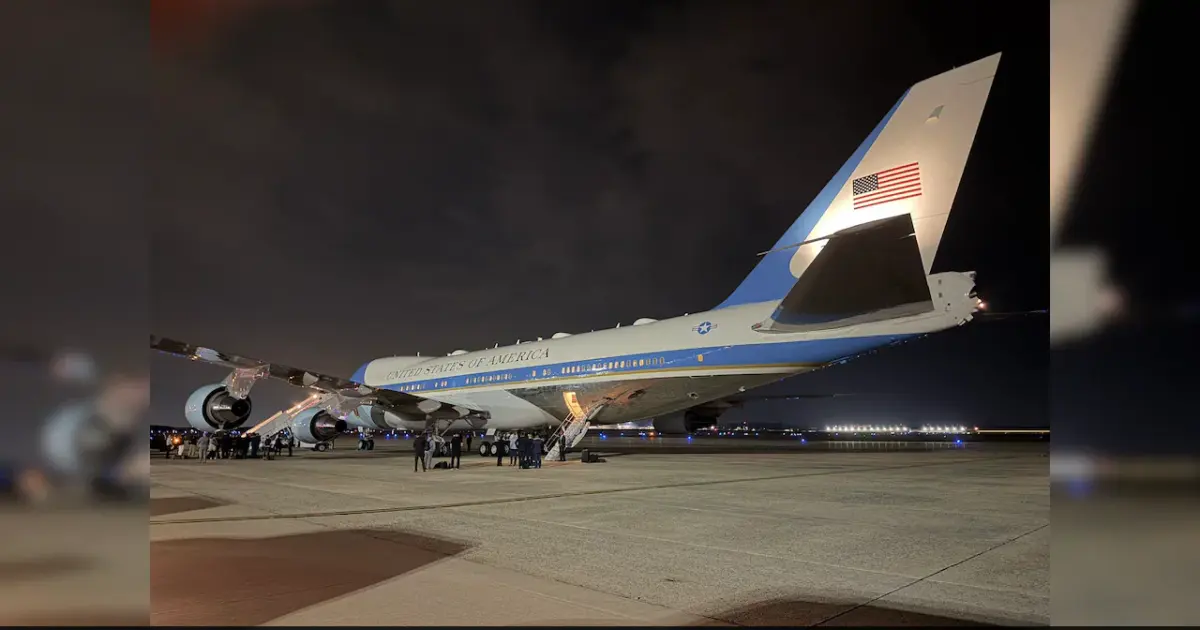 Air Force One aircraft on the tarmac with a Qatari jet in the background.