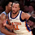 Jalen Brunson embraces Mitch Johnson after a game, highlighting their strong bond.