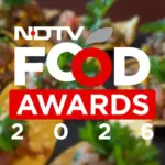Chef presenting an award at the NDTV Food Awards ceremony, highlighting culinary talent recognition.