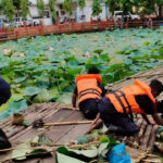 Jorhat district officials and volunteers participating in a pond restoration drive.
