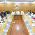 Karnataka government officials reviewing beneficiary lists for welfare schemes.