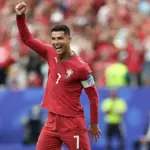 Cristiano Ronaldo celebrating a goal during a World Cup match, highlighting his record-breaking achievement.