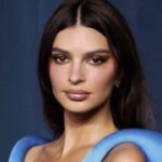 Emily Ratajkowski at an event, looking thoughtful.
