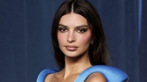 Emily Ratajkowski at an event, looking thoughtful.