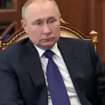 Russian flag with European Union flag in the background, symbolizing diplomatic talks.