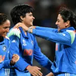Indian cricketers Shafali Verma and Smriti Mandhana smiling together on the field.