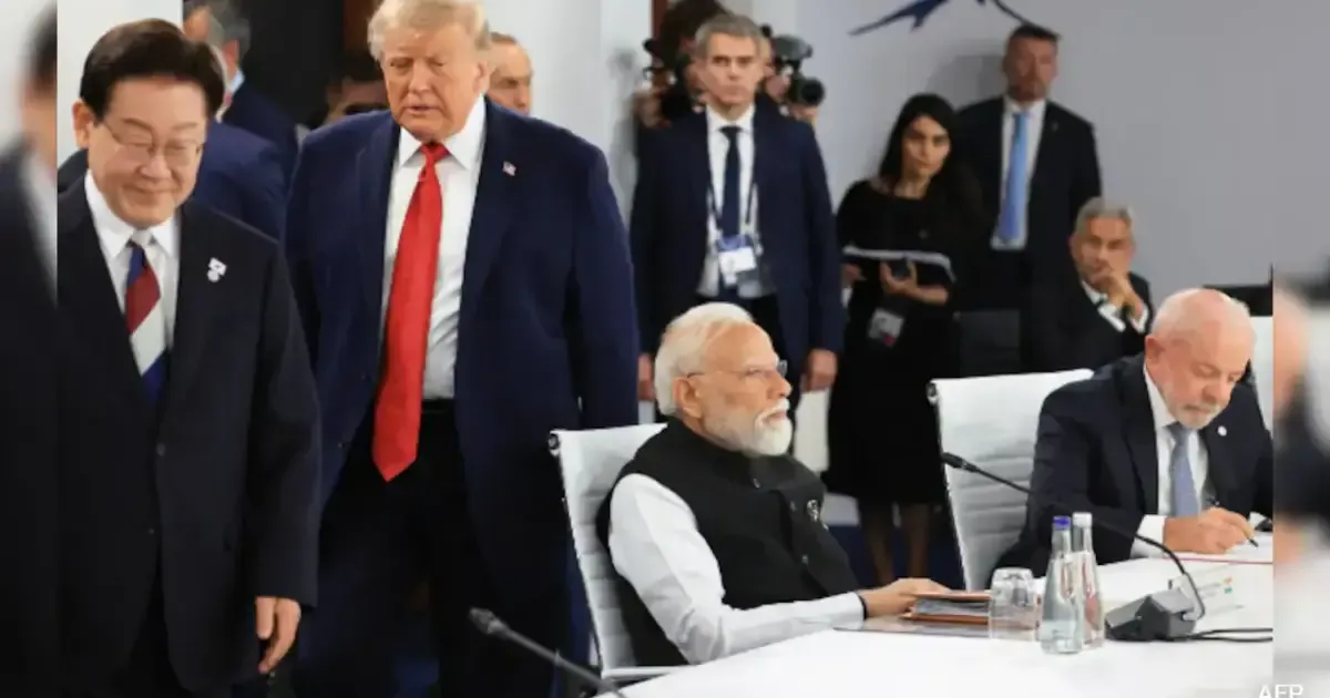 Donald Trump at the G7 Summit, smiling and gesturing.