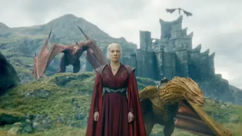A dragon soaring over a castle, representing House of the Dragon Season 3.