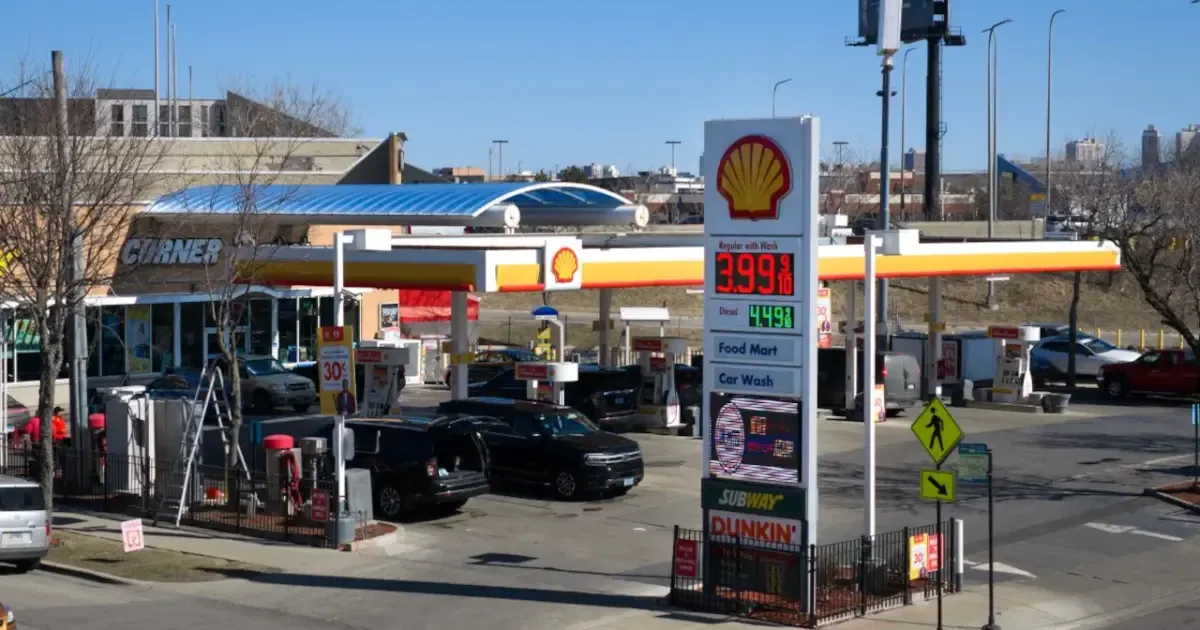 Gas pump displaying a price below $4 per gallon, symbolizing the drop in US gas prices.