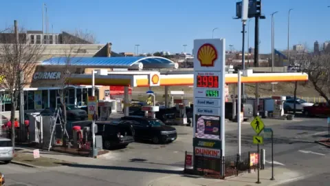 Gas pump displaying a price below $4 per gallon, symbolizing the drop in US gas prices.