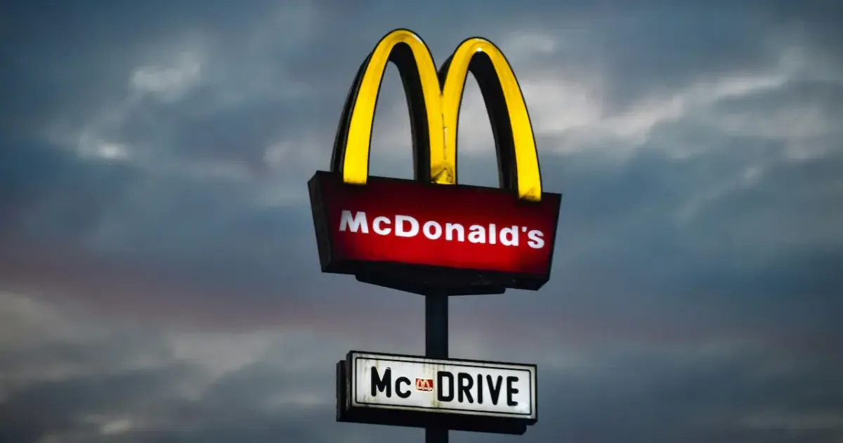 A close-up of a McDonald's Big Mac burger with fries and a drink.