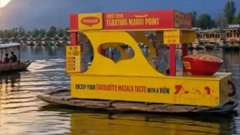 Floating Maggi point on Dal Lake, Srinagar, offering a unique culinary experience amidst stunning mountain views.