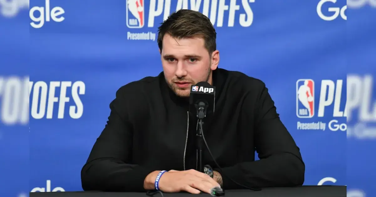 Luka Doncic in a Slovenia national team jersey, looking thoughtful.