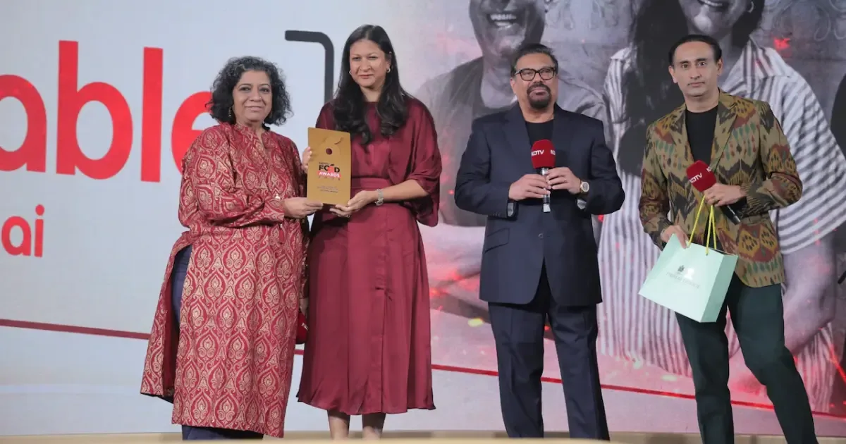 The Table Mumbai restaurant interior with happy diners celebrating their NDTV Food Awards 2026 win.