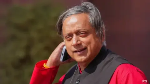 Shashi Tharoor, a prominent Congress leader, speaking at a press conference amidst a political storm over his remarks on Kashmir.
