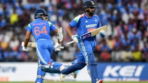 Indian cricket team players in action during an ODI match, with a focus on opening batsmen.