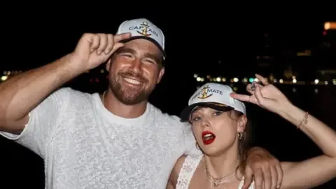 Taylor Swift and Travis Kelce in a candid moment, fueling wedding rumors.