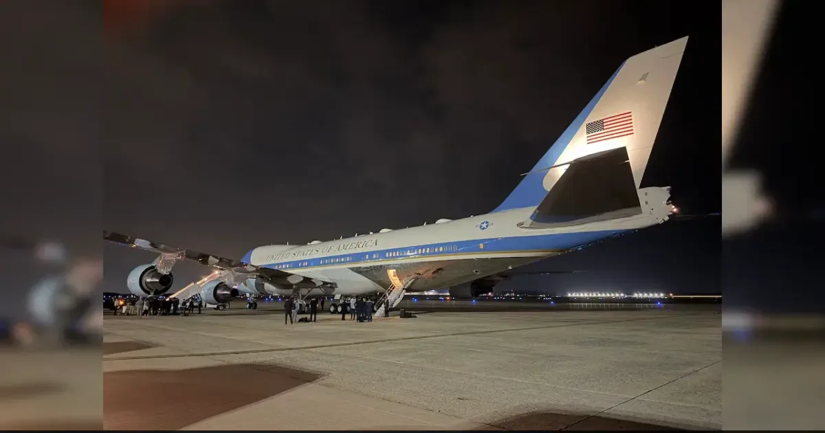 Air Force One aircraft on the tarmac with a Qatari jet in the background.