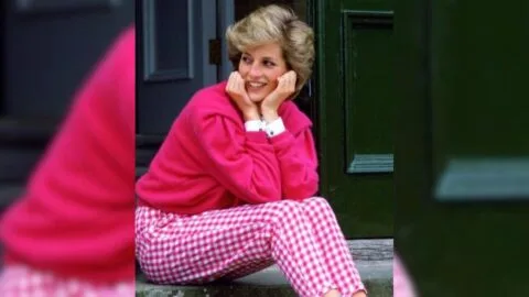 Princess Diana as a teenager reading a book, possibly a pulp romance novel.
