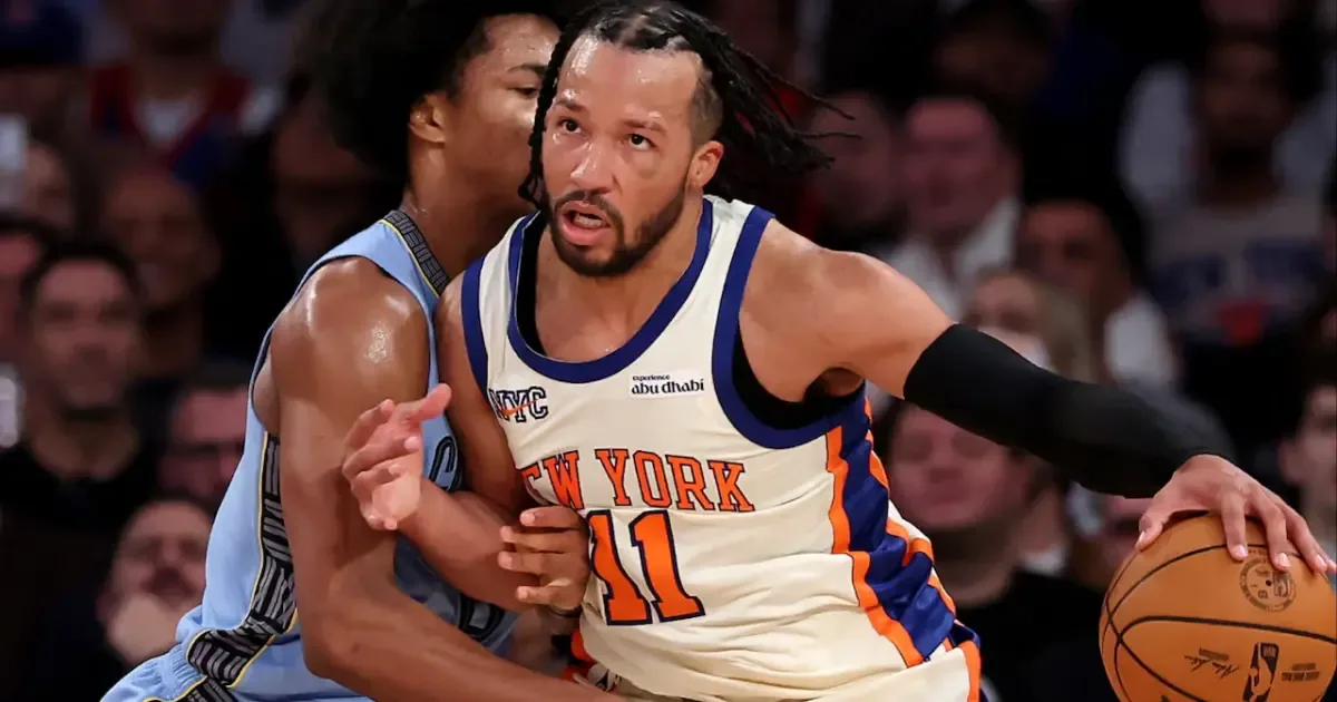 Jalen Brunson embraces Mitch Johnson after a game, highlighting their strong bond.