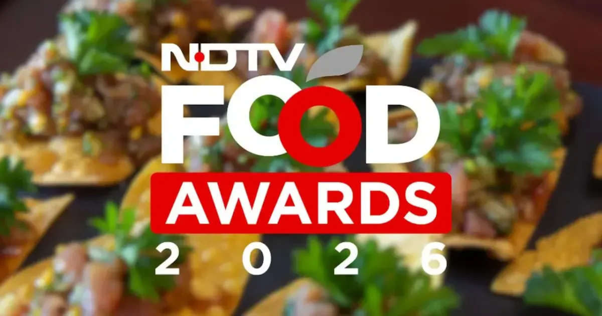 Chef presenting an award at the NDTV Food Awards ceremony, highlighting culinary talent recognition.