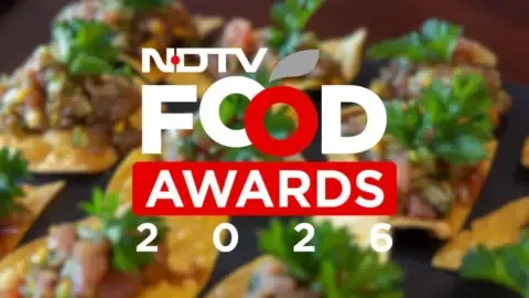 Chef presenting an award at the NDTV Food Awards ceremony, highlighting culinary talent recognition.