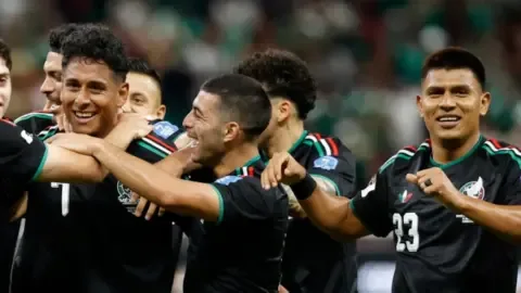 Mexico players celebrating after qualifying for the 2026 World Cup knockouts.