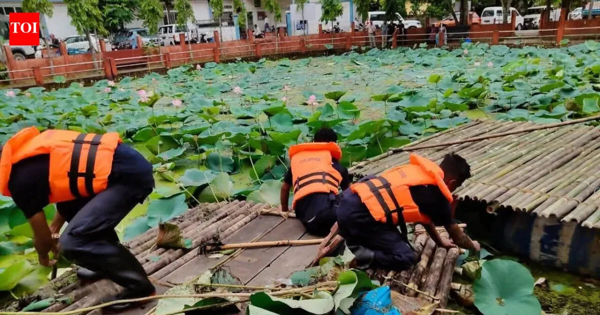 Jorhat district officials and volunteers participating in a pond restoration drive.