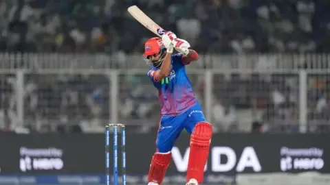 KL Rahul batting during a cricket match, with Rishabh Pant potentially returning to Delhi Capitals.