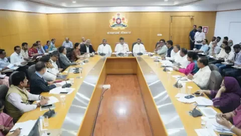 Karnataka government officials reviewing beneficiary lists for welfare schemes.