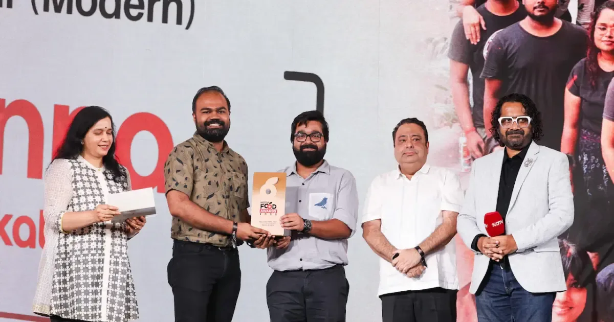 Sienna Kolkata restaurant interior with modern Indian decor and happy diners celebrating their win at the NDTV Food Awards 2026.