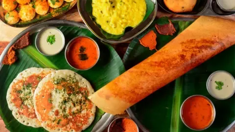 A vibrant street food stall in Bengaluru, India, showcasing a variety of delicious local dishes.