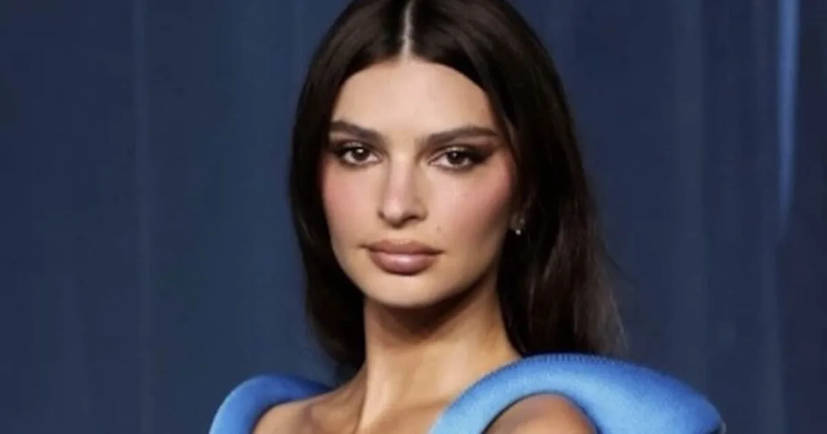 Emily Ratajkowski at an event, looking thoughtful.