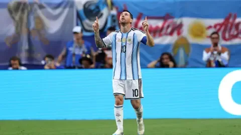 Lionel Messi dribbles past a Cape Verde defender during the intense match.